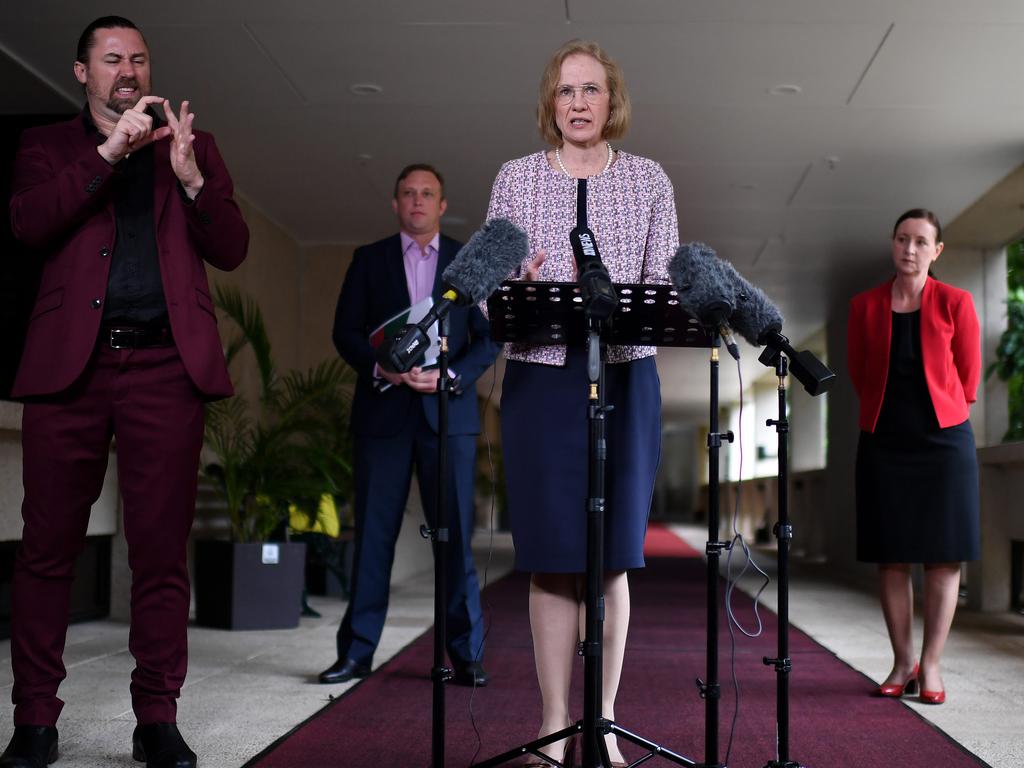 Chief Health Officer Jeannette Young speaks yesterday, flanked by a signer, Acting Premier Steven Miles and Health Minister Yvette D’Ath. Picture: Dan Peled/NCA NewsWire