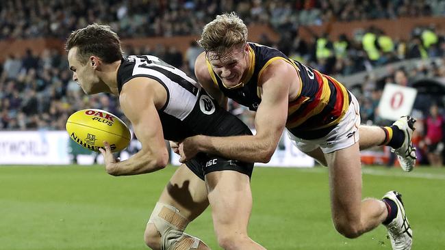 AFL — SHOWDOWN 46 — Port Adelaide v Adelaide Crows at Adelaide Oval. Alex Keath tackles Karl Amon. Picture SARAH REED