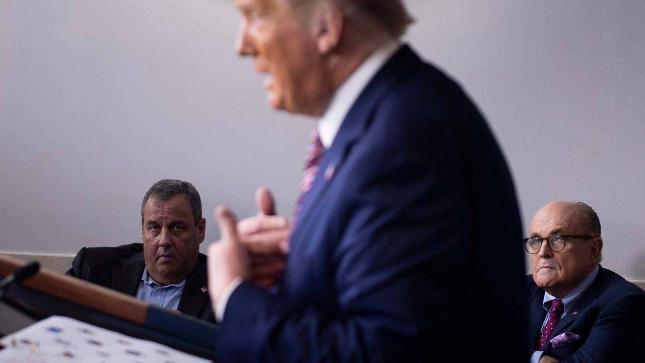 Mr Trump in the White House briefing room today, with former New Jersey governor Chris Christie and former New York mayor Rudy Giuliani watching on. Picture: Brendan Smialowski/AFP