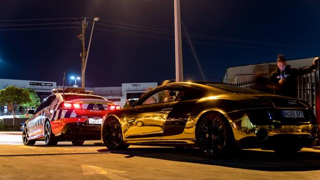 A Highway Patrol car alongside a chromed Audi R8. Photo: Sam Law - 300C-PO