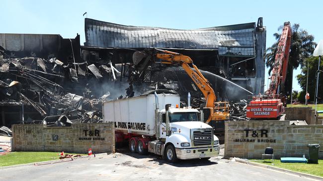 Excavators are brought in to work on the wreckage of the Thomas Foods International abattoir. Picture: Tait Schmaal