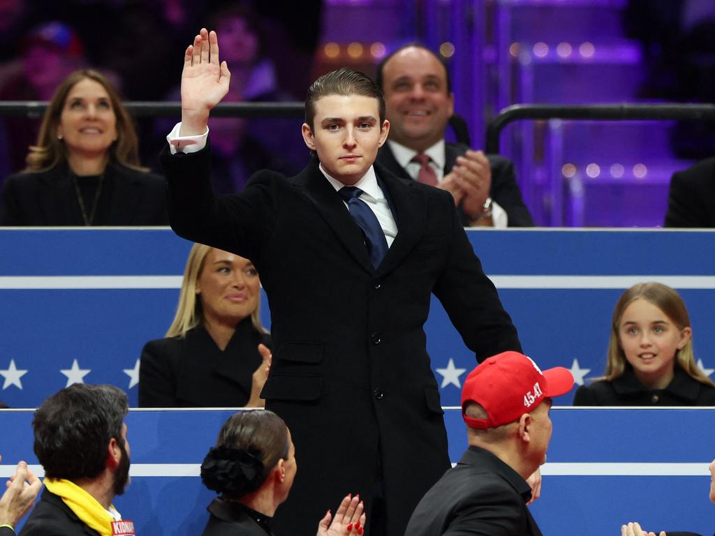 Barron Trump waves to the crowd during an indoor inauguration parade at Capital One Arena on after the president introduced him on stage Picture: Tasos Katopodis/Getty Images/AFP