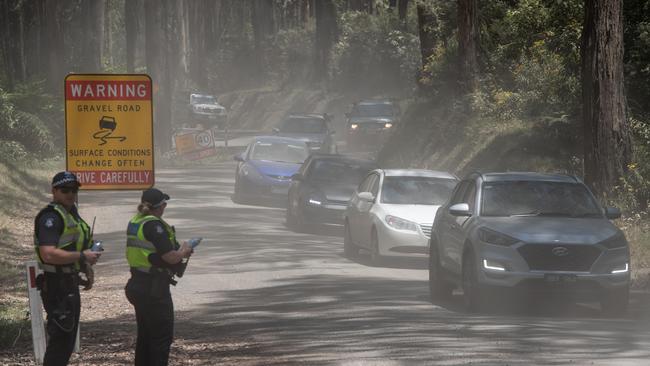 Police control traffic as over 9000 campers are evacuated from the Falls Music Festival in Lorne. Picture: Jason Edwards