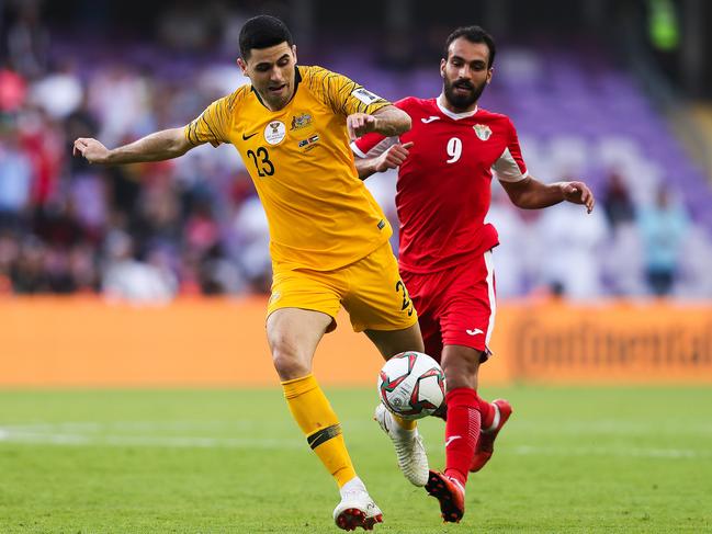 AL AIN, UNITED ARAB EMIRATES - JANUARY 06: Tom Rogic of Australia is challenged by Baha' Faisal of Jordan during the AFC Asian Cup Group B match between Australia and Jordan at Hazza Bin Zayed Stadium on January 06, 2019 in Al Ain, United Arab Emirates. (Photo by Francois Nel/Getty Images)
