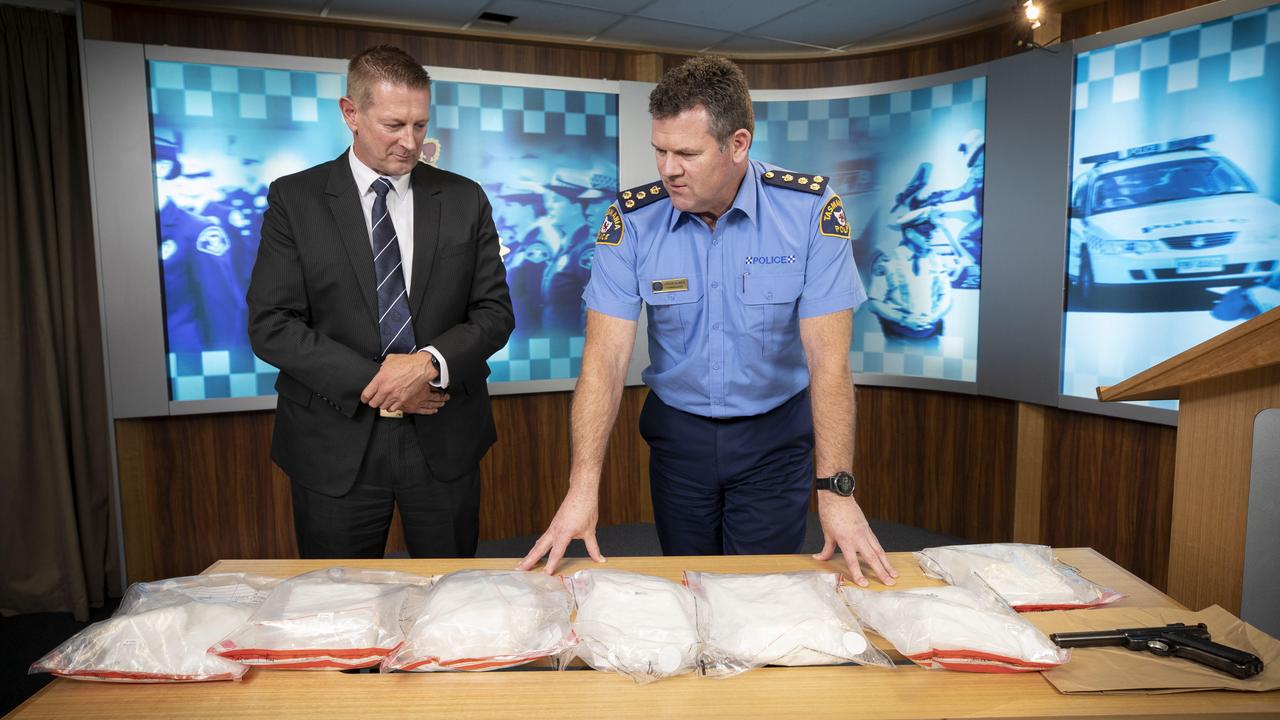 Detective Inspector David Gill and Commander Jason Elmer with the $4.6m worth of seized drugs, and firearm. Picture: Chris Kidd