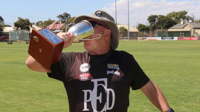 Jarman drinks from the premiership cup. Picture: Port District Football Club