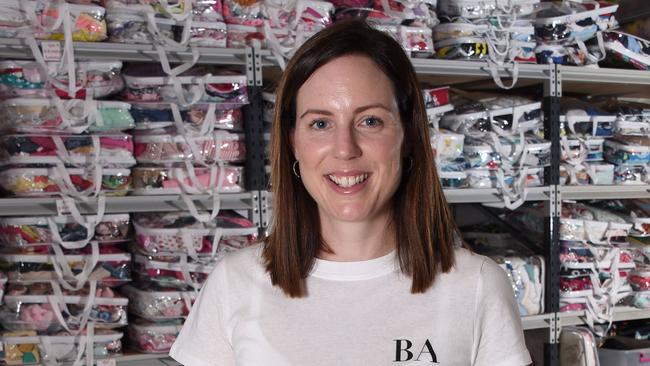 Carly Fradgley the founder of "Baby Give Back", a charity that helps disadvantaged families with small children pictured at their West Burleigh warehouse. (Photo/Steve Holland)