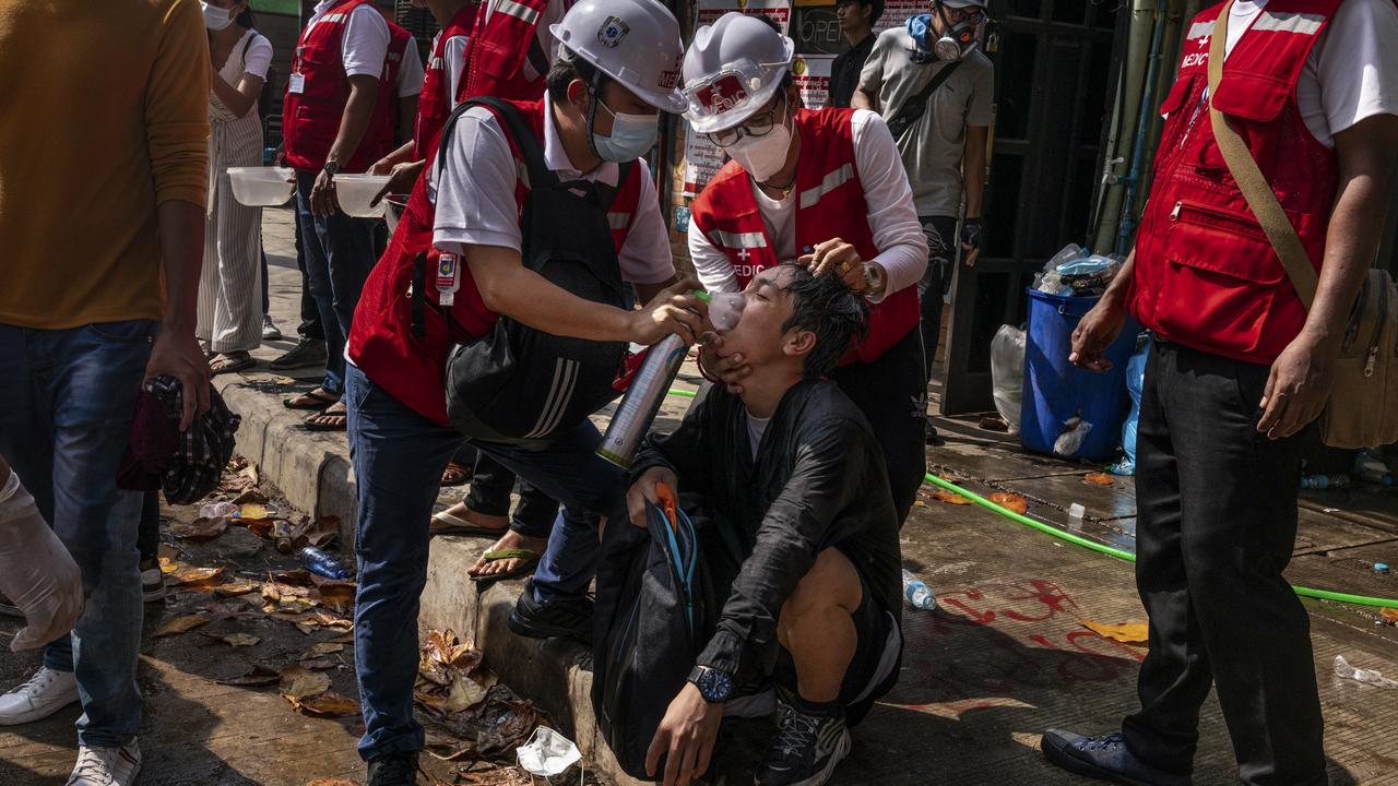 Medics help supply oxygen to protesters who were exposed to tear gas during clashes on March 3 in Yangon, Myanmar. Picture: Stringer/Getty Images