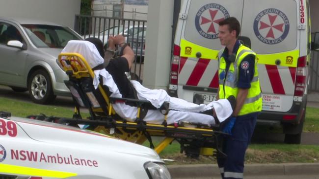 A man “laughed and winked” at onlookers before he was loaded into an ambulance and taken to Westmead Hospital in a stable condition. Picture: TNV