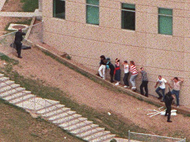 Nightmare scenario ... Aerial view of students being led from Columbine High School on the day of the massacre. Picture: Supplied