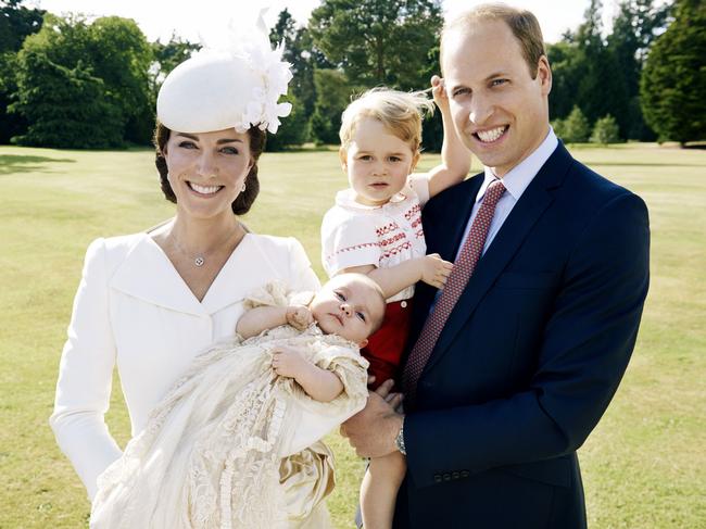 Britain’s Prince William, and Kate Duchess of Cambridge hold their children, Prince George, and Princess Charlotte in the grounds of Sandingham House in England after the christening of the princess on Sunday July 5, 2015. Picture: Mario Testino/AP