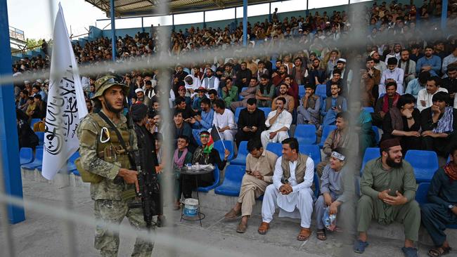 A Taliban fighter keeps vigil as spectators watch the Twenty20 cricket match at the Kabul International Cricket Stadium. Picture: Aamir Qureshi / AFP