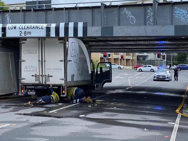 The truck hit a rail bridge near Indooroopilly station.