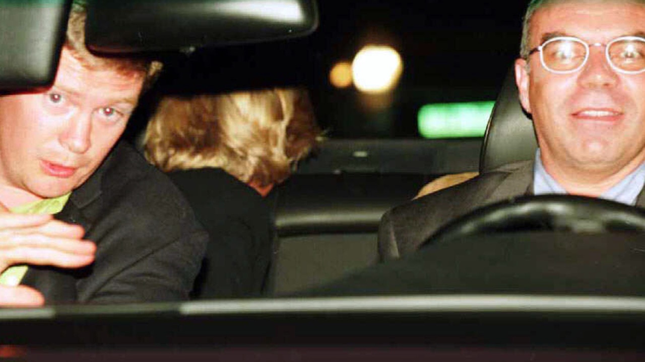 Bodyguard Trevor Rees-Jones and driver Henri Paul with Princess Diana, peering at paparazzi out of the back window of their Mercedes Benz.