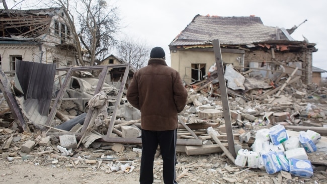 Local resident looks at a shelled area on March 5, in Markhalivka, Ukraine. Regional police said six people died, including a child in a Russian air strike on this village southwest of Kyiv. Picture: Getty