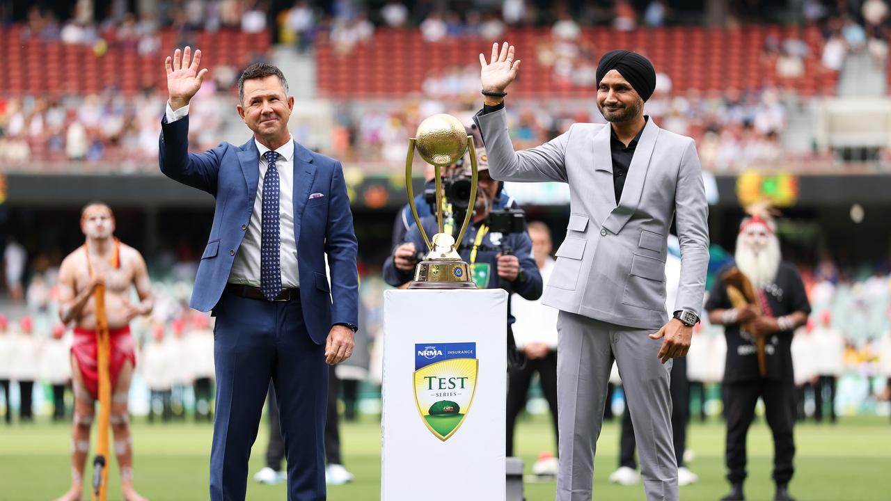 Ricky Ponting and Harbhajan Singh wave to the crowd next to the Border-Gavaskar Trophy at Adelaide Oval. (Photo by Robert Cianflone/Getty Images)