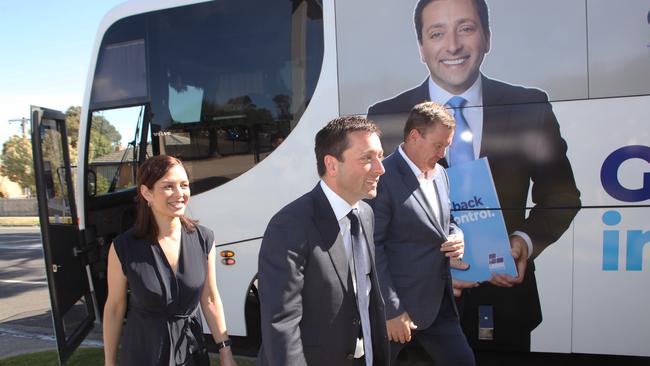 Victorian Leader of the Opposition Matthew Guy alights his campaign bus in Frankston with wife Renae Guy, left, and Liberal candidate for Frankston Michael Lamb in Melbourne. Picture: AAP