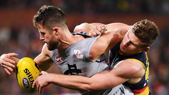 Rory Laird latches on to former Adelaide teammate now Carlton forward Matthew Wright. Picture: Mark Brake/Getty Images