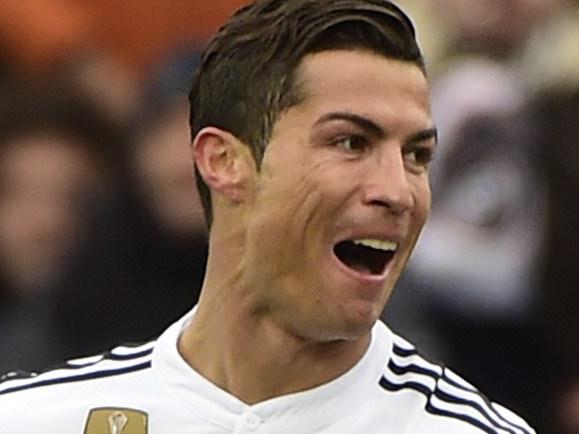 Real Madrid's Portuguese forward Cristiano Ronaldo celebrates after scoring during the Spanish league football match Getafe CF vs Real Madrid CF at the Coliseum Alfonso Perez stadium in Getafe on January 18, 2015. AFP PHOTO/ PIERRE-PHILIPPE MARCOU