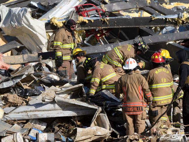 Emergency workers search through what is left of the Mayfield Consumer Products Candle Factory after it was destroyed by a tornado in Mayfield, Kentucky. Picture: John Amis / AFP)