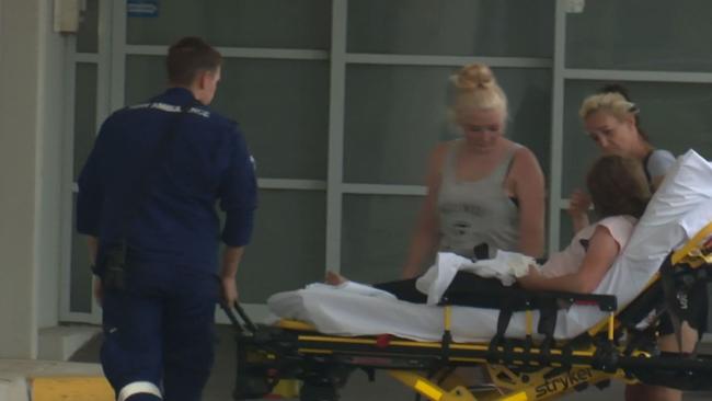 A 10-year-old girl who was bitten on the back is transported to hospital. Picture: TNV