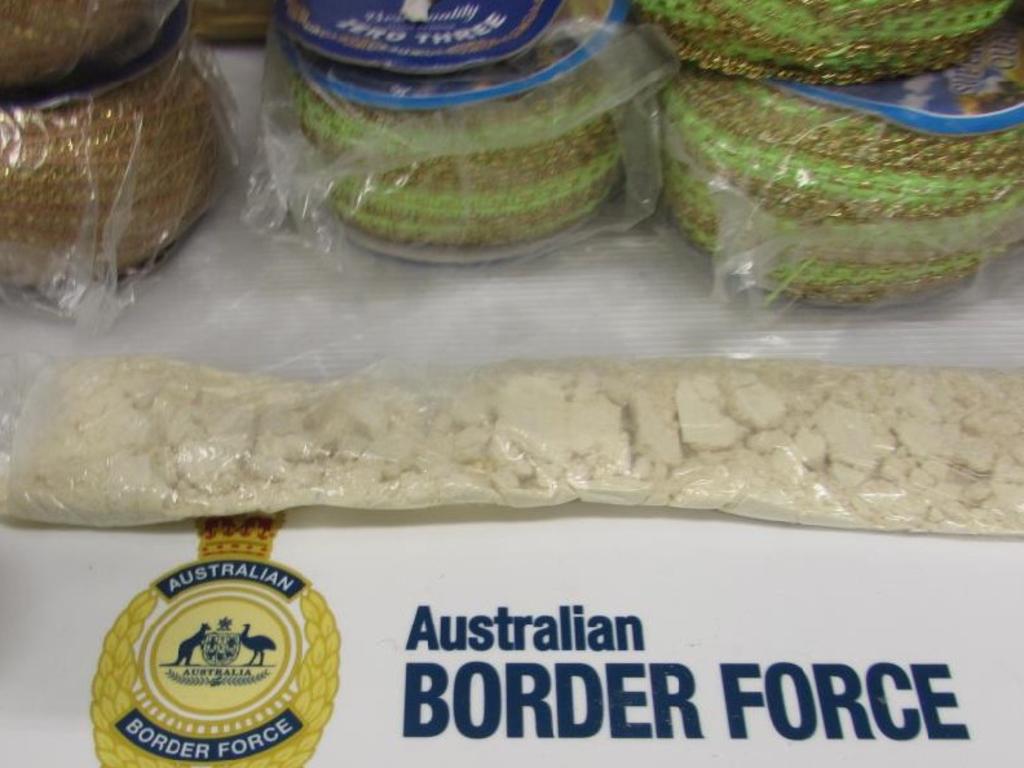 A 20-year-old Queensland man was arrested and charged after police allegedly seized almost 1kg of heroin, $42,650 in cash, and quantities of MDMA and cocaine.