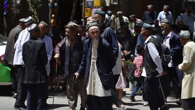 Uighur men are seen leaving a mosque after prayers in Hotan in China's northwest Xinjiang region. Picture: AFP