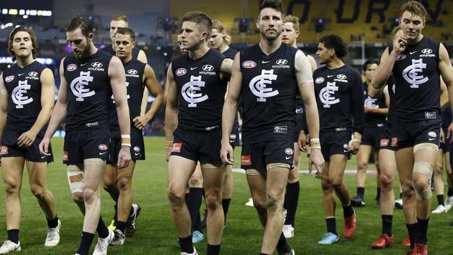 Carlton players walk off after the loss to Adelaide.