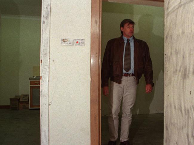 Police officer Denis Edmond inside the disused bank vault where eight victims were found in six plastic barrels.