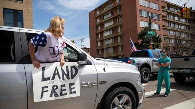 Opposing protesters stand-off in Denver as tensions rise in the US over whether to maintain coronavirus restrictions. Picture: Alyson McClaran