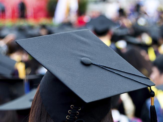 Rear view of graduation caps during commencement.