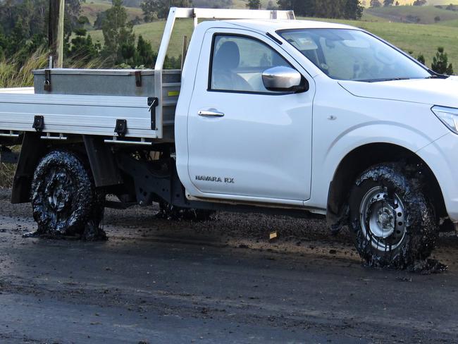 A local is forced to abandon his ute after it became completely stuck to the road. Picture: David Anthony