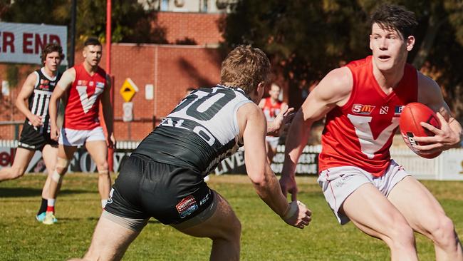 Port's Jack Strange attempt to stop North's Sam McInerney. Picture: AAP/Matt Loxton