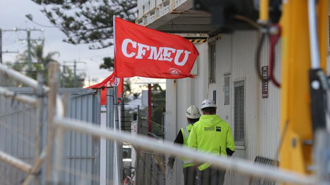 Workers on The Jewel site this afternoon. CFMEU flag still flying at this stage. Picture Glenn Hampson