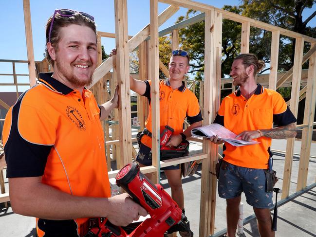 TAFE carpentry apprentices Ethan Sutherland and Karl Van Rijssen with apprentice manager Steve Purcell working on a 54-townhouse development at Richlands. Picture: Tara Croser.