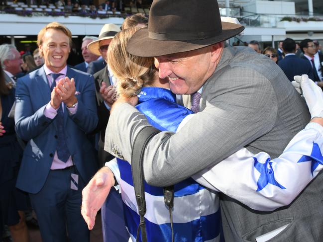 Trainer David Hayes hugs Jamie Kah after her amazing achievement.