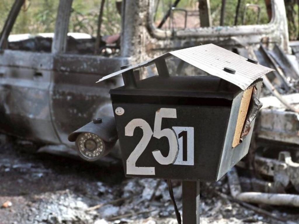 A burnt out vehicle at the entrance to the Train property at Wieambilla.