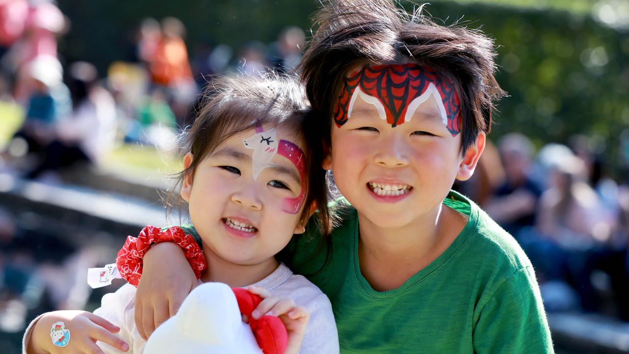 3 year old Aria and her older brother 5 year old Oliver pose for photographs at the Cherry Blossom Festival in Auburn. (AAP IMAGE / Angelo Velardo)