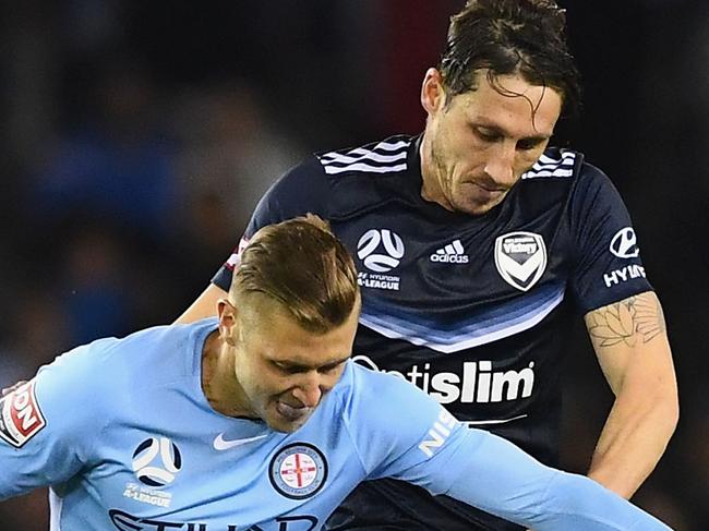 MELBOURNE, AUSTRALIA - OCTOBER 14:  Marcin Budzinski of the City and Mark Milligan of the Victory compete for the ball during the round two A-League match between Melbourne Victory and Melbourne City FC at Etihad Stadium on October 14, 2017 in Melbourne, Australia.  (Photo by Quinn Rooney/Getty Images)