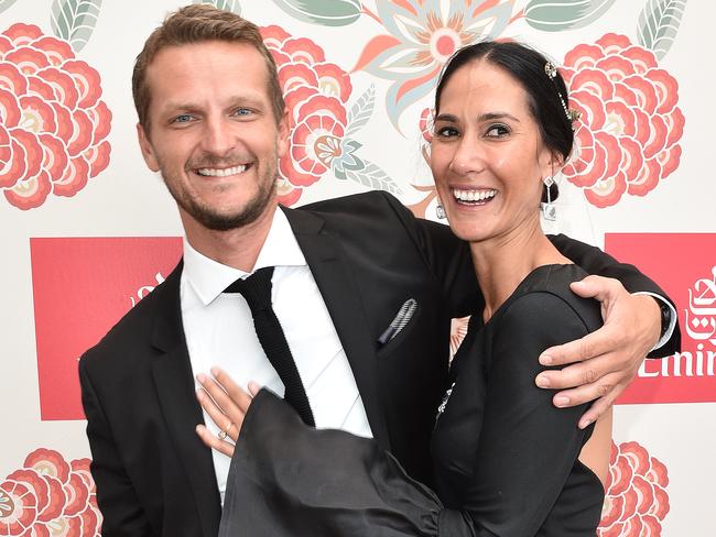 Lindy Klim and her new boyfriend Adam Ellis hug in the Emirates marquee on Derby Day at Flemington Racecourse in Melbourne, Saturday. Oct. 29, 2016. (AAP Image/Julian Smith) NO ARCHIVING, EDITORIAL USE ONLY