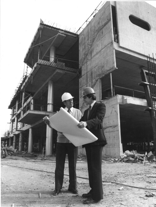 Builders looking at plans during the Colonnades build in 1978.