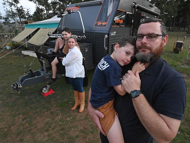 01/09/2020: Corey Hobbins with his wife Rachael and their kids Lachlan 9 and holding Taj 5, in front of the caravan at the home in Witheren, in the hills behind the Gold Coast. Corey is planning on living in the caravan over the border in NSW to save his business over the border closures due to the Covid lock downs   Pic Lyndon Mechielsen