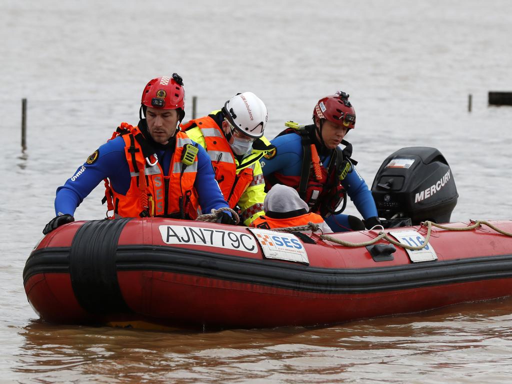 An elderly lady is evacuated from Ellis Lane near Camden on Sunday morning. Picture: Jonathan Ng