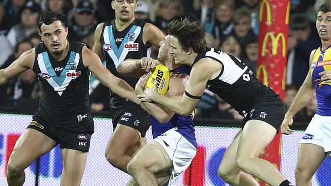 Jared Polec tackles Luke Shuey, giving away a free kick for too high. Picture Sarah Reed