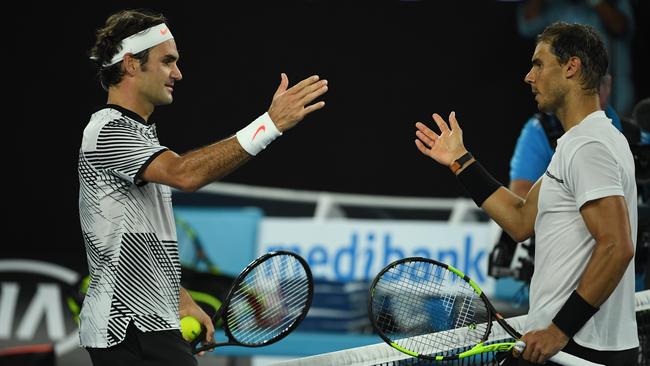 Roger Federer of Switzerland (left) celebrates his win in the Mens Singles Final against Rafael Nadal of Spain (right).