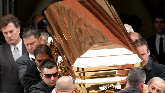 The gold coffin with the body of gangland killer Carl Williams leaves the funeral service at a church in Essendon, Melbourne. Pic. Stuart Mcevoy