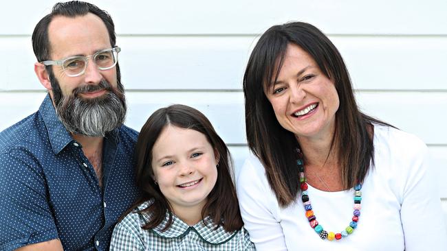 PROUD PARENTS: Mark Nielsen and Yvette Miller with their daughter Harper, 9, who refuses to sing the national anthem. Picture: Annette Dew