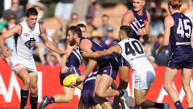 Connor Blakely looks to break from a Michael Gibbons tackle. Picture: Paul Kane/Getty Images.