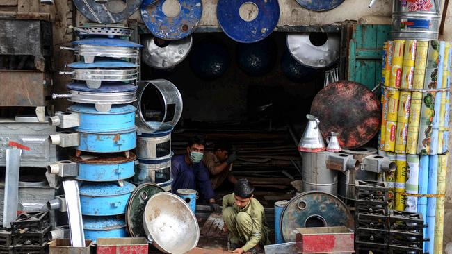 Blacksmiths work in a shop in Kandahar. Picture: AFP