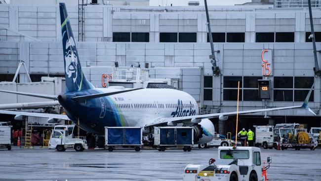 An Alaska Airlines Boeing 737 MAX 9 plane sits at a gate at Seattle-Tacoma International Airport.